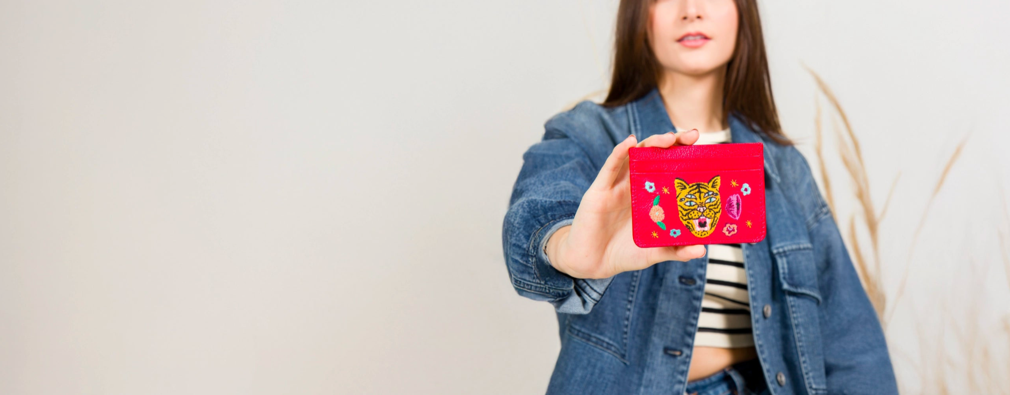 A display featuring "Squid Charms" by Min & Mon, a NYC-based brand, includes a yellow toy taxi and a mini Empire State Building. The colorful charms, shown in pink, blue, and red, highlight the brand's unique accessories.
