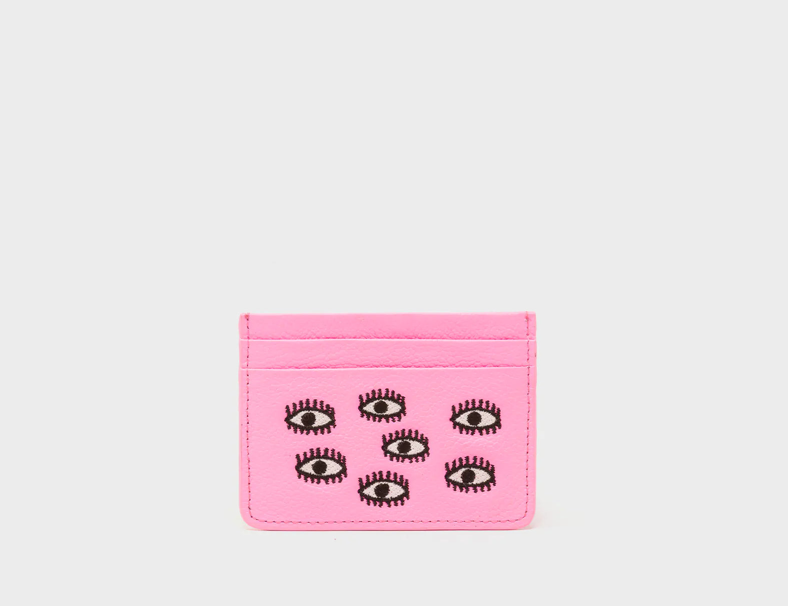 Pink cardholder with eye designs on a white background