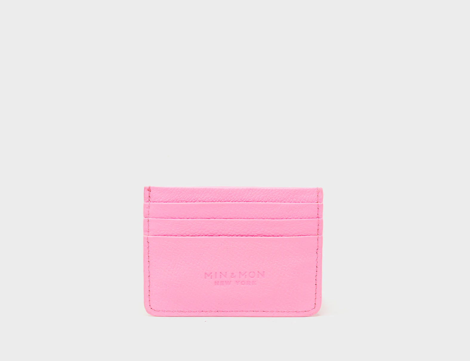 Pink cardholder with brand name on a light gray background