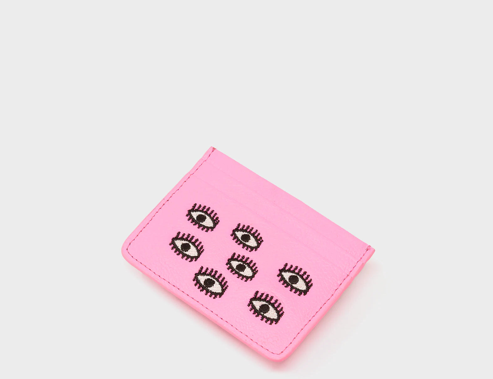 Pink cardholder with eye designs on a white background