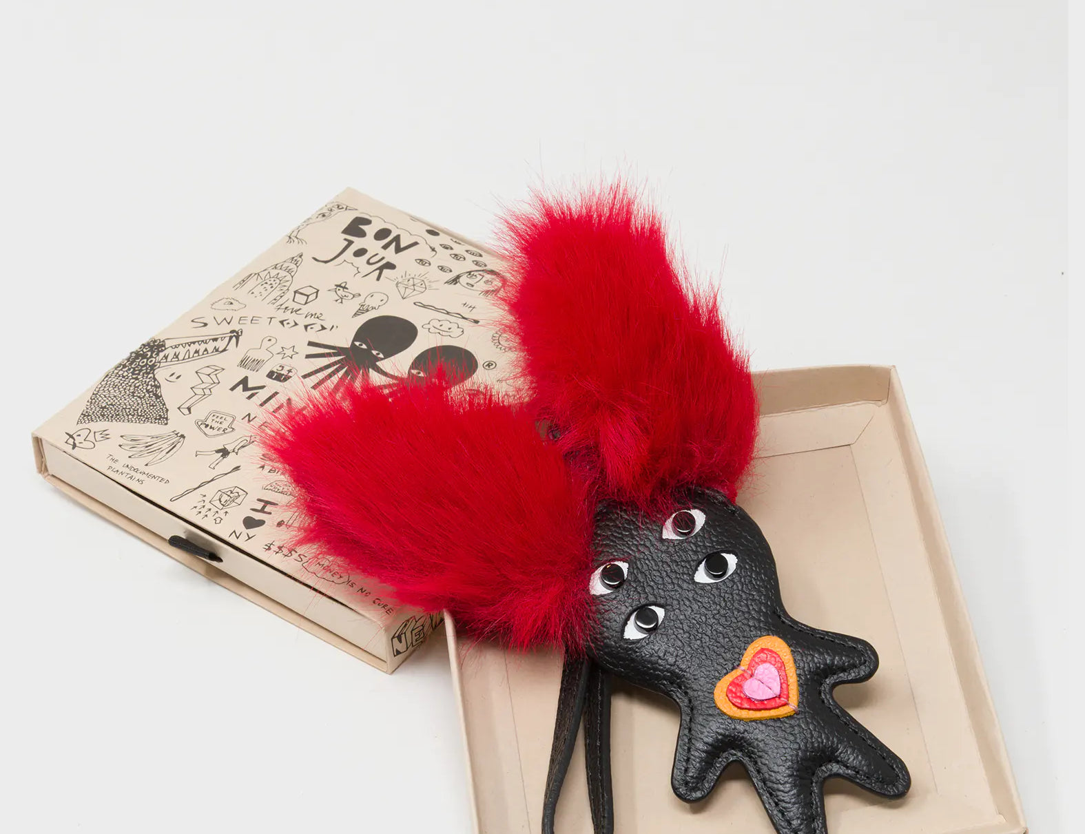Fluffy Fella - Black and Red Leather Bag Charm - Box View
