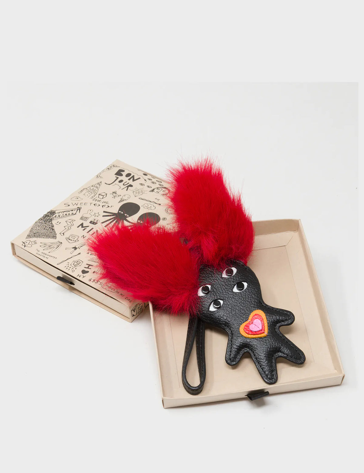 Fluffy Fella - Black and Red Leather Bag Charm - Box View