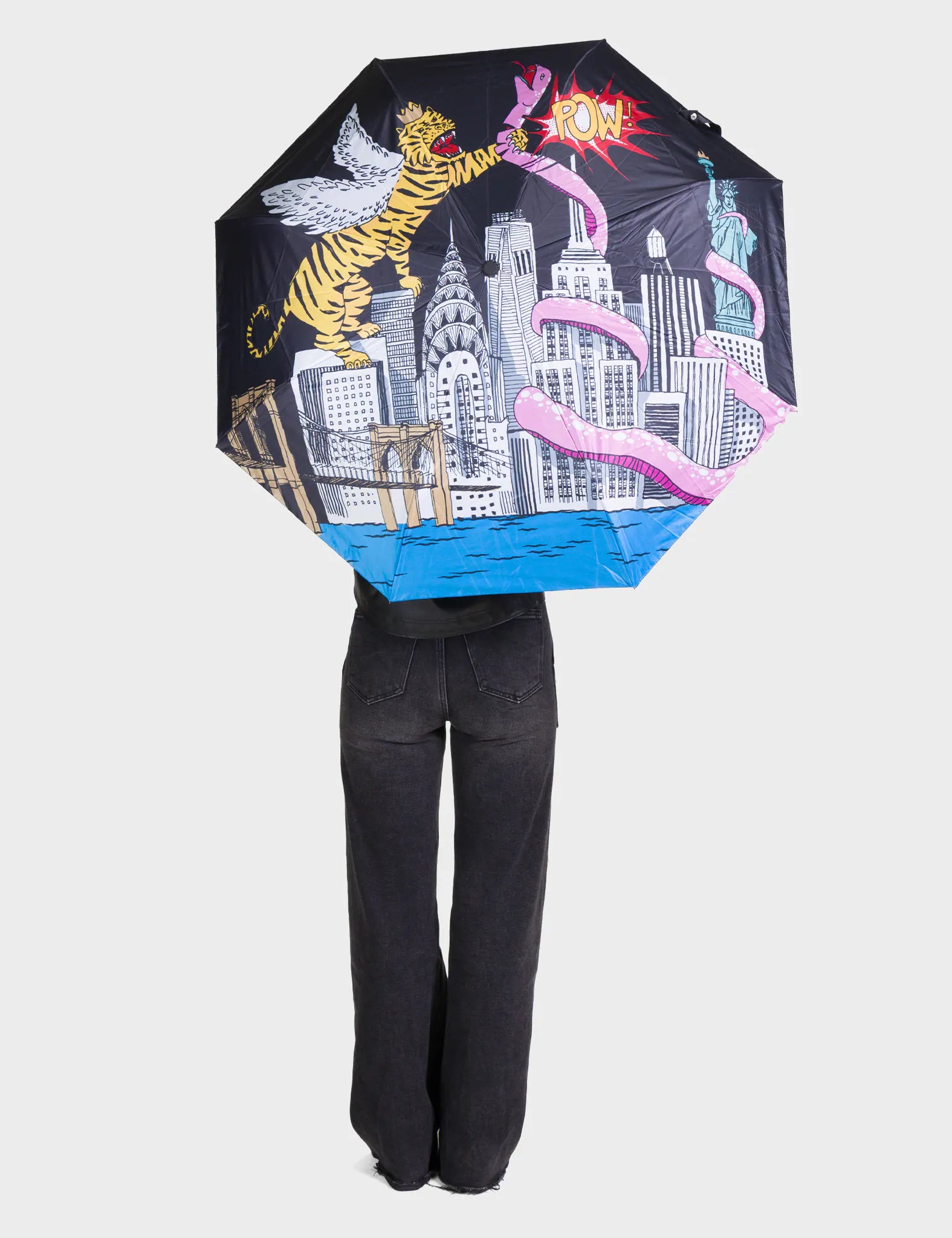 Umbrella with colorful design featuring a cityscape, tiger, and other elements on a white background.