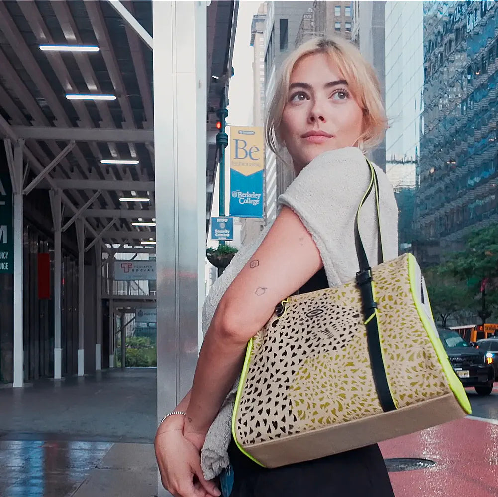 Close-up of a model carrying the Min & Mon Wild Heart jaguar print tote bag with neon green details in New York City.