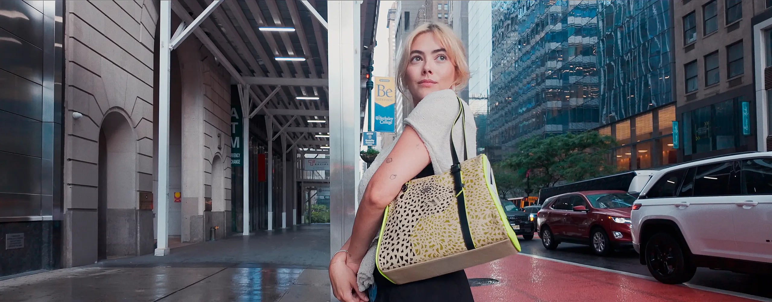 Model wearing the Min & Mon Wild Heart tote bag in jaguar print while walking through the streets of New York City.
