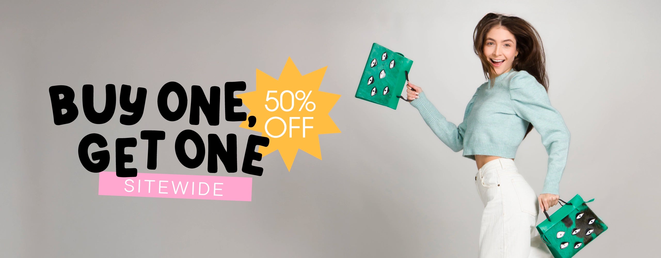 Min & Mon BOGO banner featuring a woman in a mint sweater and white pants holding two green handbags embroidered with playful eye motifs. Text reads: “Buy One, Get One 50% OFF sitewide.”