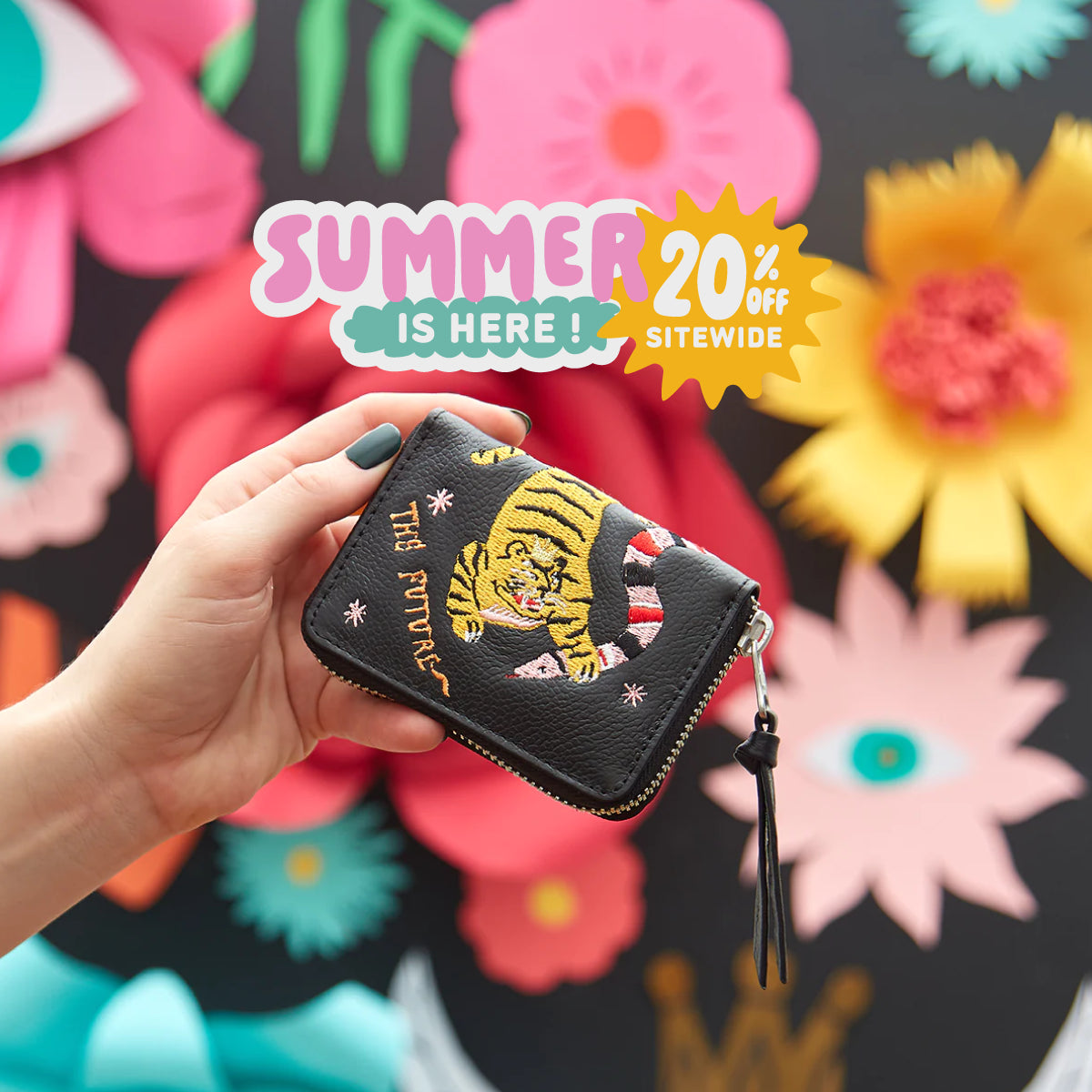 Min & Mon wallet with embroidered tiger displayed against a colorful floral backdrop in the Summer is Here campaign featuring 20% OFF sitewide.