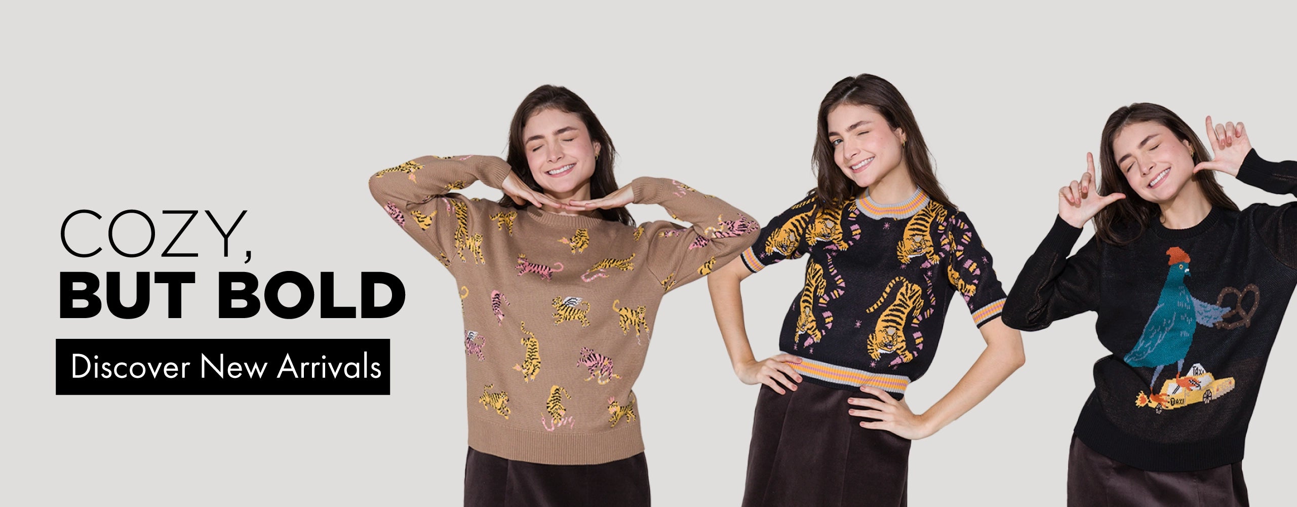 Models wearing playful, illustrated knit sweaters by Min & Mon, posing joyfully against a clean, light background.