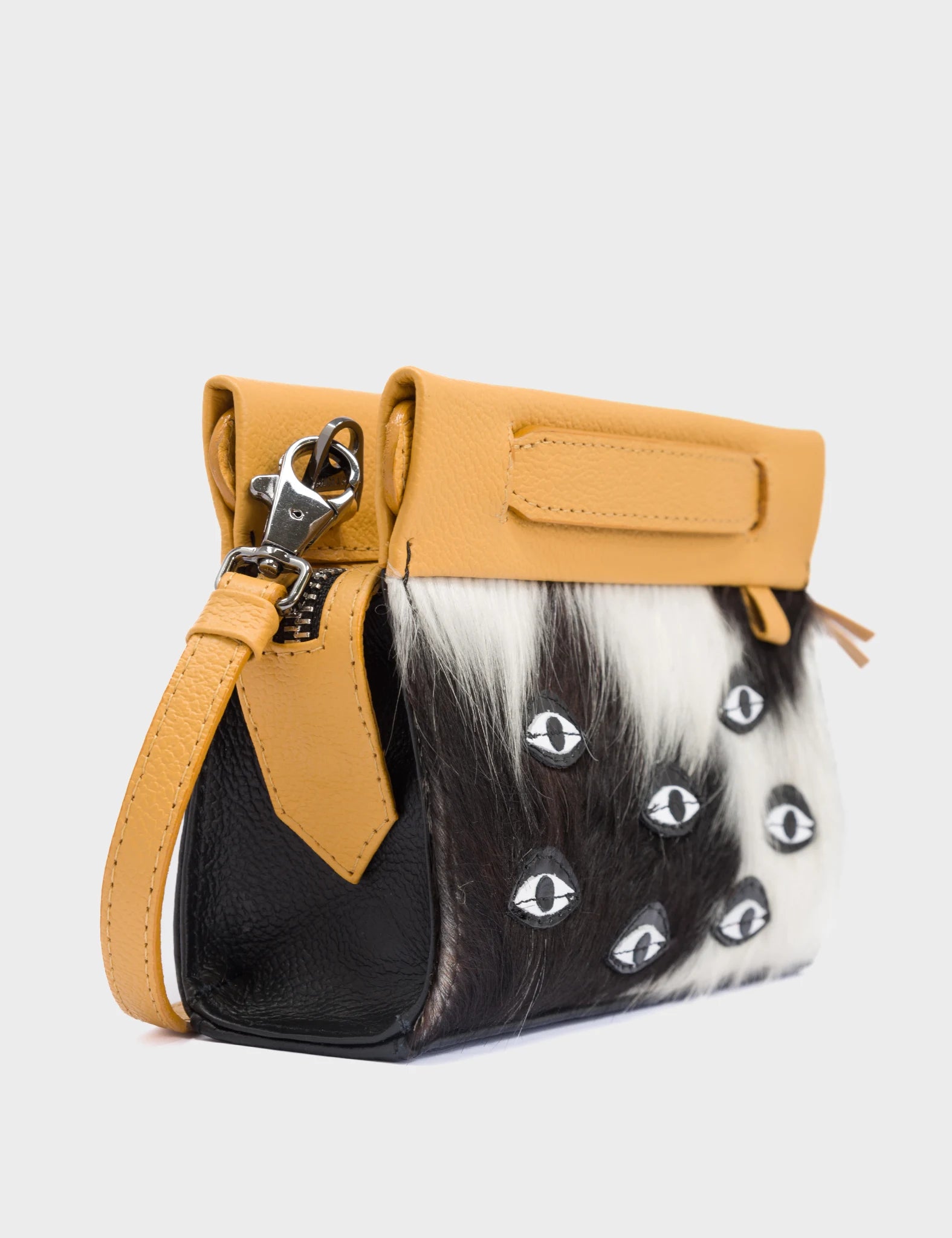 Vali Crossbody Micro Golden Glow and Black Leather Bag - Eyes Applique Adjustable Handle - Black and White Fur - Side Corner View