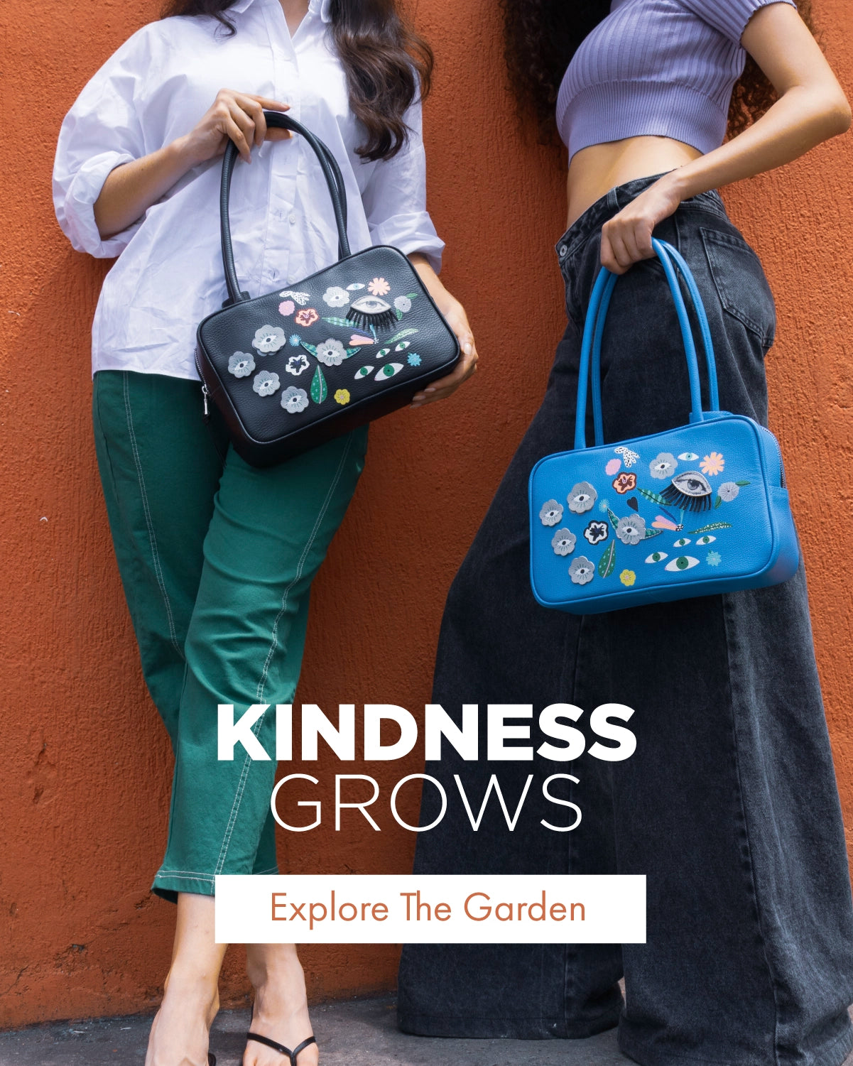 Floralia handbags in black and blue leather featuring floral and eye illustrations, styled against a terracotta backdrop.