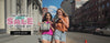 Women walking through New York City wearing and carrying Min & Mon handbags, smiling, exploring the city, and enjoying everyday moments together, with The Summer Edit Sale graphic showing up to 50% OFF.