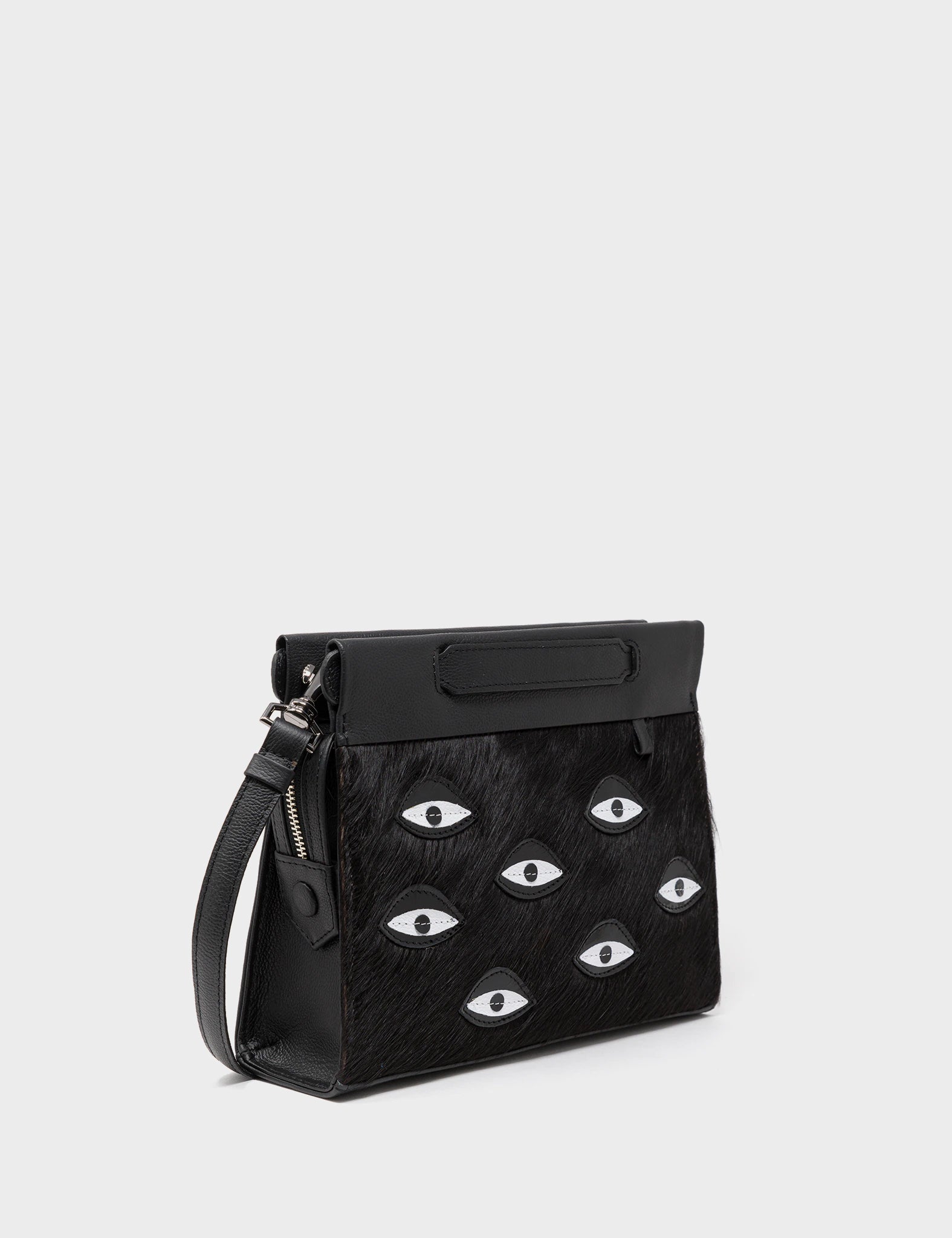 Vali Crossbody Small Black Leather Bag - Eyes Applique Adjustable Handle - Front corner angle view 