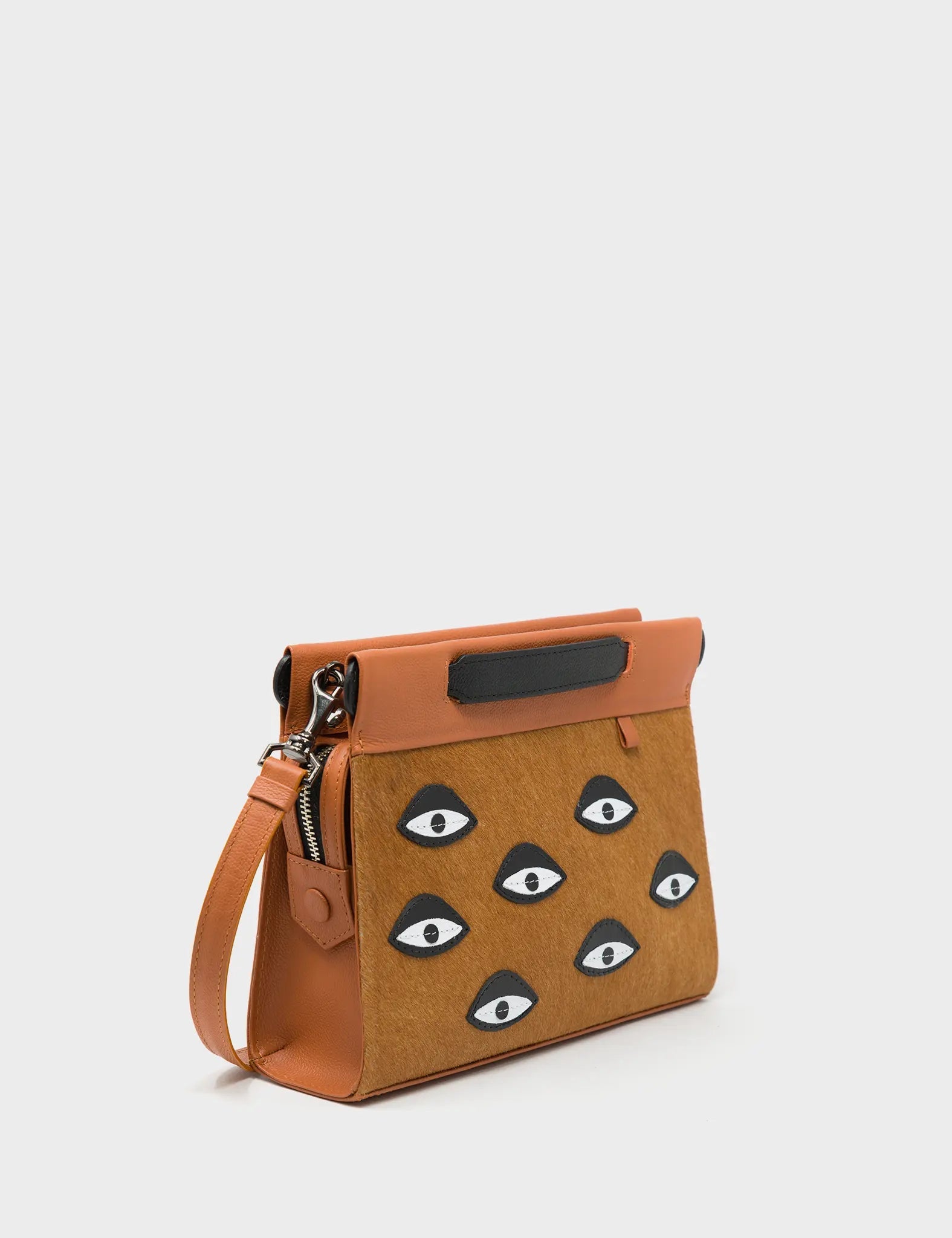 Vali Crossbody Small Caramel Leather Bag - Eyes Applique Adjustable Handle - Front corner angle view